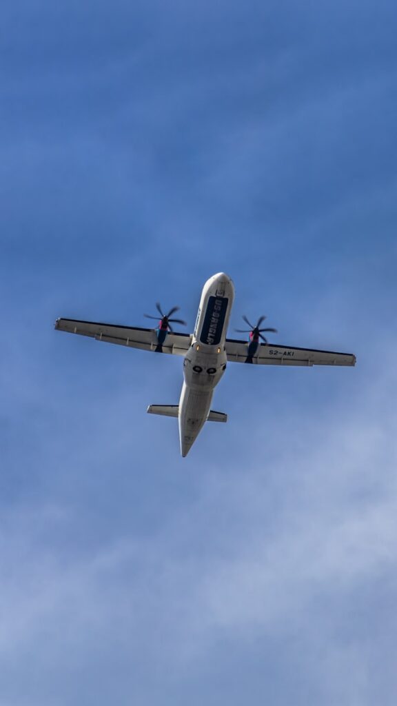 An airplane is flying in the sky on a sunny day