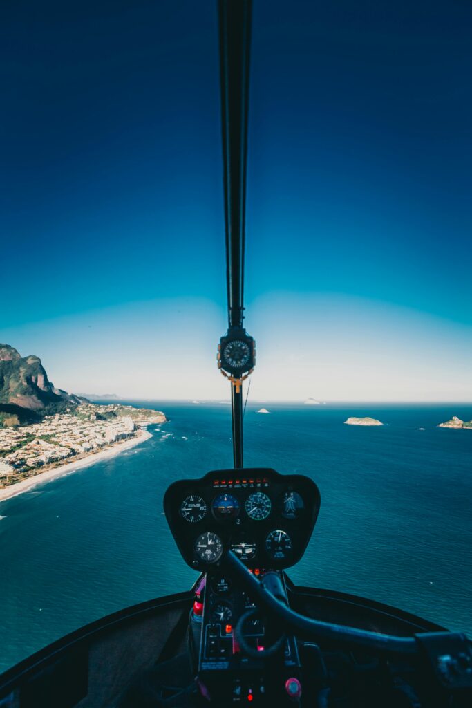 A breathtaking aerial view from a helicopter cockpit over Rio's stunning coastline and ocean view.