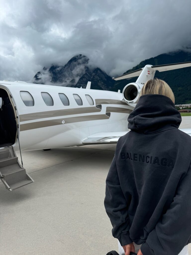 A man standing in front of a private jet