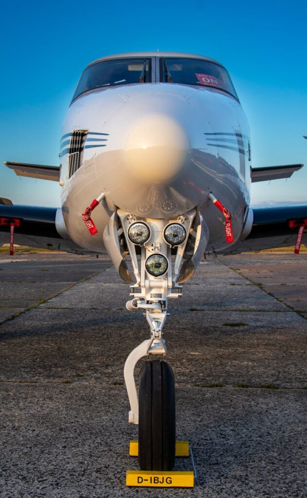 Close-up frontal shot of a private jet, showcasing aircraft nose and landing gear.